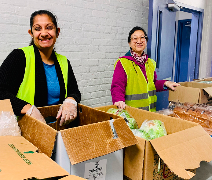 people with yellow vests working with produce
